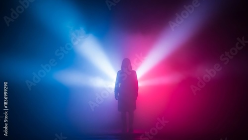 Silhouette of a person standing in dramatic red and blue neon lights and smoke