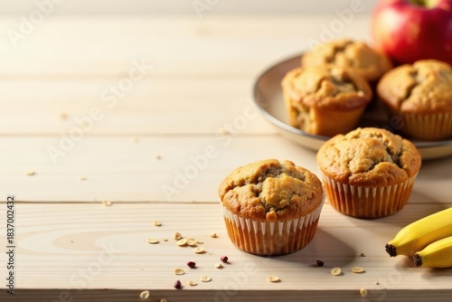 Delightful Baked Goods A Collection of Golden-Brown Muffins and Ripe Bananas on a Light Wood Surface