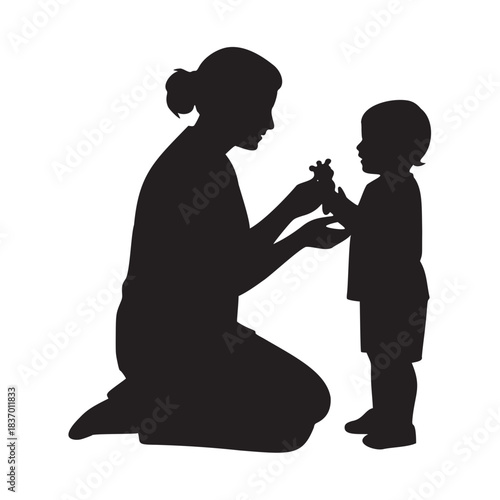 Loving mother kneeling to share a tender moment with her small child against a dark background