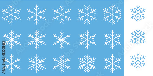 Delicate snowflakes falling gently on light blue background create a magical winter wonderland, perfect for holiday designs.