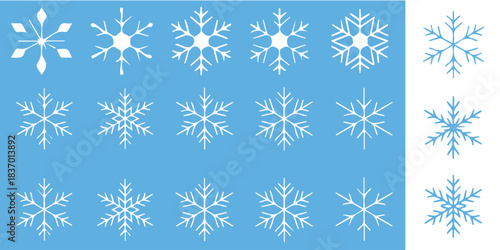 Delicate snowflakes falling gently on light blue background create a magical winter wonderland, perfect for holiday designs.