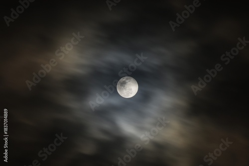 full moon covering by cloud floating on sky in night background