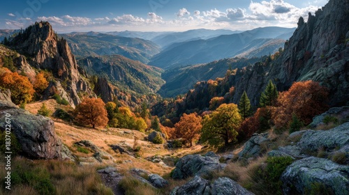 Fototapeta Naklejka Na Ścianę i Meble -  Scenic vista showcases hiking path winding through autumn mountain landscape in Tatry National Park, Poland, with colorful foliage and rocky peaks under blue sky