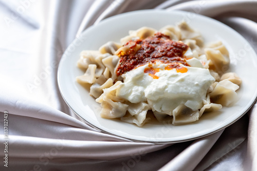 Close-Up of Turkish Manti Dumplings on a White Plate