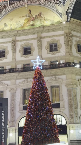 A large Christmas tree decorated for the 2025 season stands beneath the historic dome of Galleria Vittorio Emanuele II. Milan, Italy 