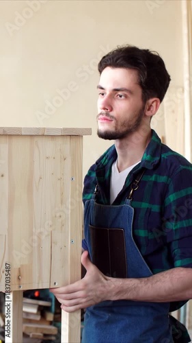 Carpenter conducting visual inspection of wood products, working with wooden products in workshop, Vertical video