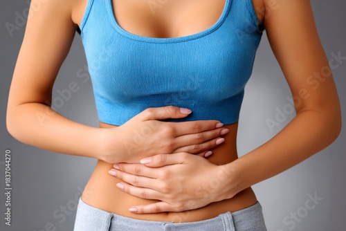 Wallpaper Mural Woman showing discomfort and pain in her stomach area Torontodigital.ca