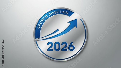 Circular emblem with blue arrow pointing upwards indicating growth direction and the year 2026 on a metallic silver background