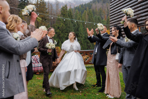Wedding celebration in a forest lodge with joyful guests and a beautiful couple