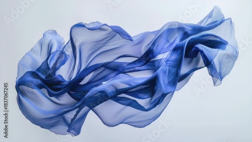 Video A blue scarf blowing freely in the wind on a white surface, ideal for use as a background or to represent movement and freedom