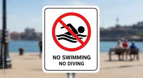No Swimming No Diving Sign at Waterfront with Cityscape Backdrop.
