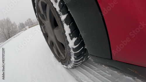 Car wheel sliding on snow during winter driving with ABS braking action