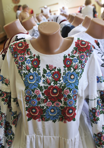 Variety and colourful Ukrainian embroidered women's dresses in shop for sale. Traditional embroideries showcasing cultural heritage of Ukraine.
