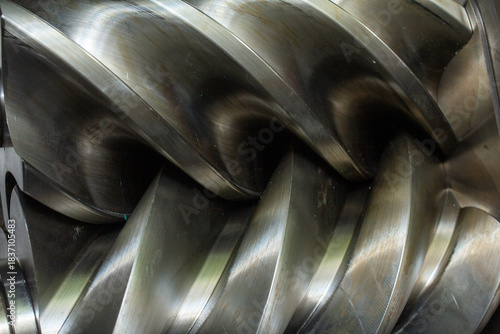 Helical screw compressor rotor lobe and its surrounding housing plate, highlighting precision engineering for air compression and heavy machinery components