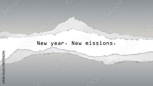 Inspirational quote “New year. New missions.” on grey gradient background with torn paper texture. Minimalist motivational typography focused on new goals and purpose.