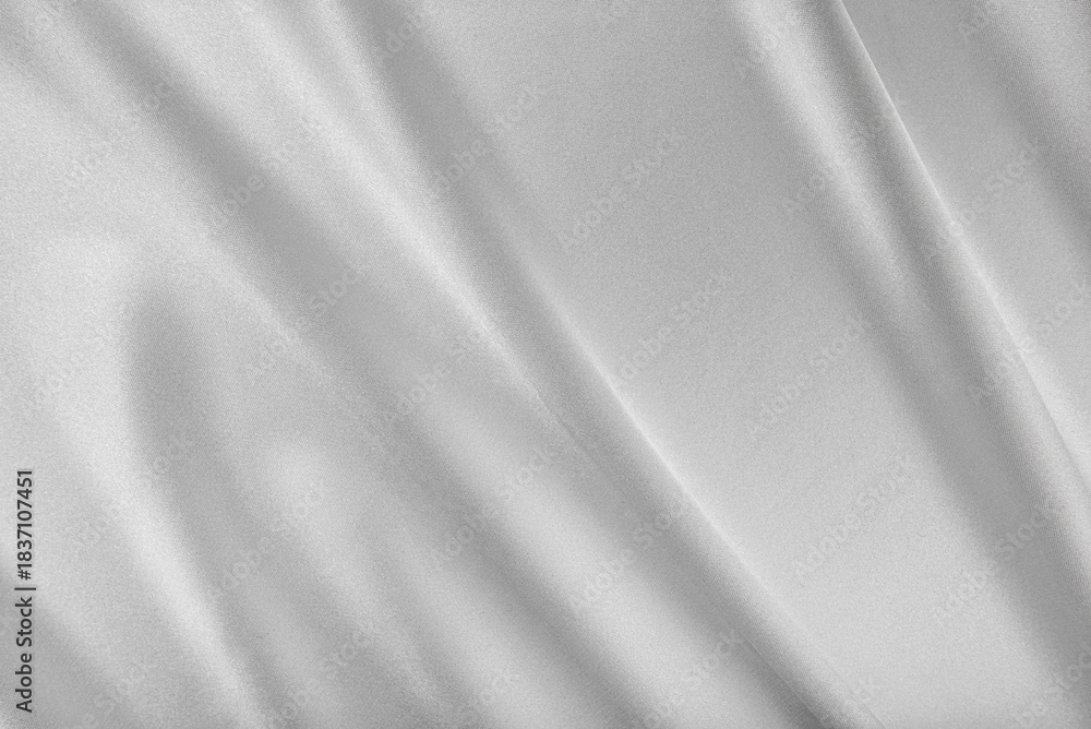 Fototapeta premium Luxurious silver satin fabric with elegant, flowing folds and a soft, shimmering texture.
