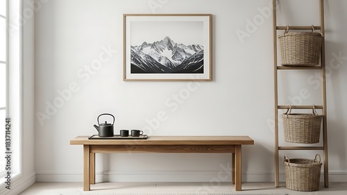 Minimalist Japandi style living room with wooden bench and framed mountain photograph.