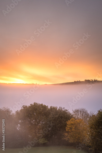 Orange dawn sky with cloud inversion 