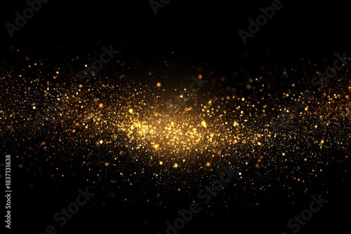 Golden particles floating against a dark background creating a glow
