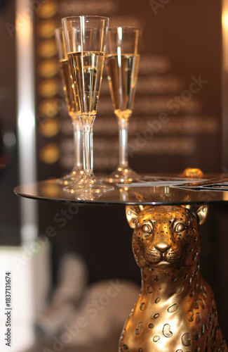 Sparkling wine stock photo. Champagne flutes on dining table. Toast or holiday celebration. 