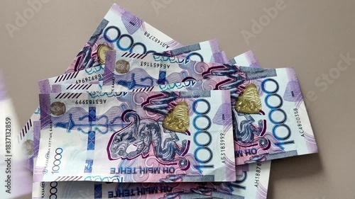 Counting a stack of 10000 kazakhstani tenge banknotes. Close-up view of the national currency of kazakhstan for finance and business concepts