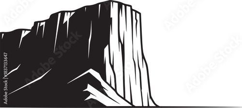 Black silhouette of a large vertical rock formation