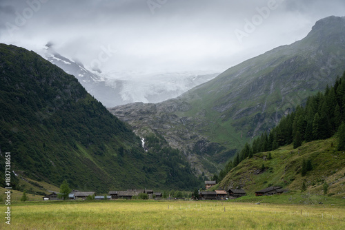 Wallpaper Mural Picturesque alpine village nested in a valley with massive glacier above it, Austrian Alps Torontodigital.ca