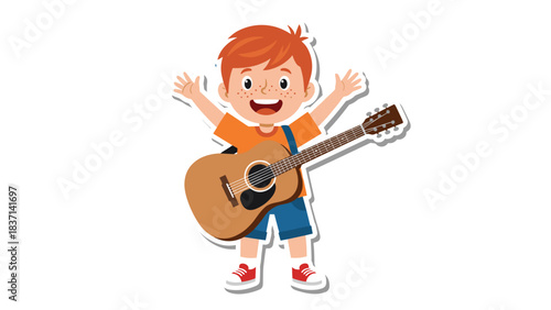 Joyful young boy with ginger hair wearing an orange t-shirt and blue overalls holding a brown acoustic guitar with his arms raised in a cheerful pose against a black background