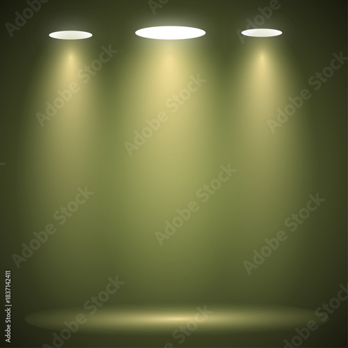 Three warm yellow spotlights brightly illuminate a deep olive-green stage or wall, creating a dramatic, empty display area ideal for presentations or product showcases.