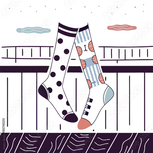 Whimsical colorful socks with polka dots and stripes hanging on a railing  