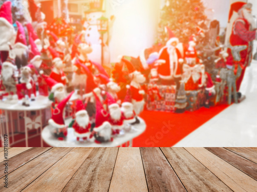 Wooden table top over Christmas ornaments background at department store.