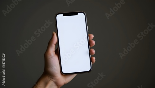 Hand Holding A Blank Screen Smartphone Against A Minimalist Background