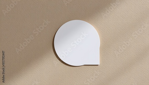 Minimalist White Circular Wall Decoration on Textured Beige Surface in Contemporary Interior