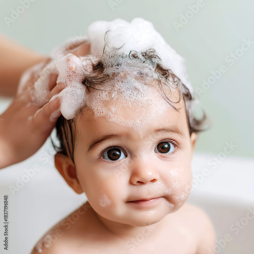 Little baby girl enjoying a bath and hair washing