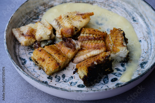 Grilled Eel or Anguilla on Patato Puree, a Speciality Dish from Comacchio at the Delta of the River Po in Italy