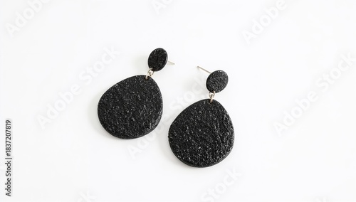 Lava stone earrings porous black natural volcanic textured boho design on plain white background