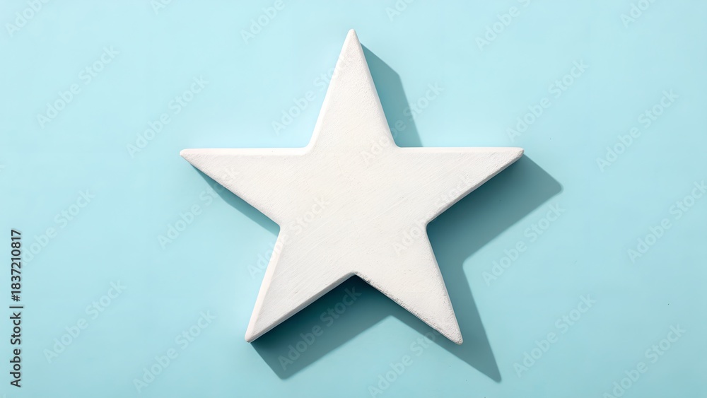 Obraz premium A Single White Star Shape Centered On A Soft Blue Background With Dramatic Shadows
