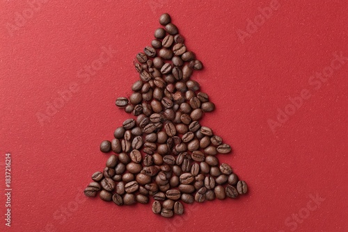 Coffee beans forming christmas tree on red background, copy space