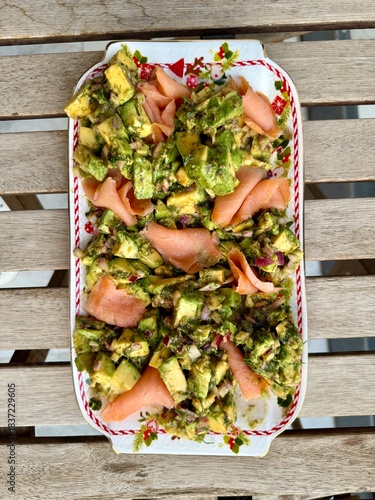 Salad with smoked salmon, avocado, and green leaves. Ideal healthy lunch or dinner concept