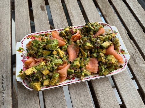 Salad with smoked salmon, avocado, and green leaves. Ideal healthy lunch or dinner concept