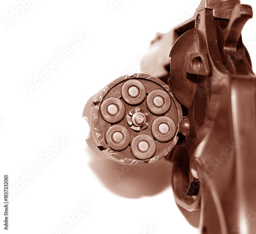 Loaded revolver pistol with cartridges isolated on white background close-up