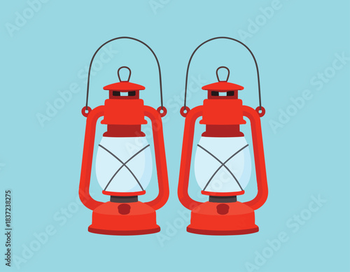 Two identical red vintage oil lanterns with glass globes and handles on a light blue background.