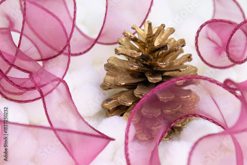 a golden-painted pine cone, which is a common item for seasonal home decor.