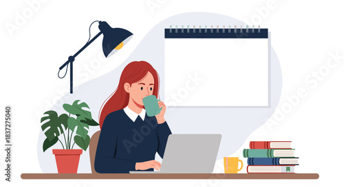 Young woman with red hair works on her laptop at a desk while drinking coffee with a blank calendar on the wall.