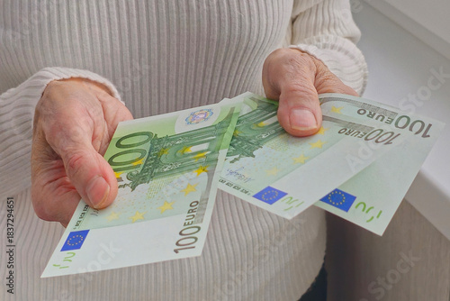 A pensioner with euro banknotes in his hands