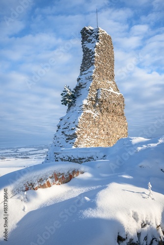 Stary Jicin castle ruins. Snow-covered dominant remnant of the wall in the upper courtyard. Czech Republic.