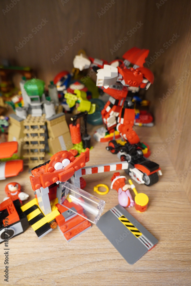 Obraz premium Colorful Lego creations on a shelf, featuring a robot, motorcycle, and more