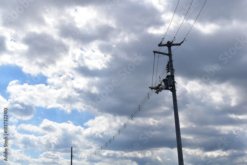 Power lines and poles on a cloudy day.