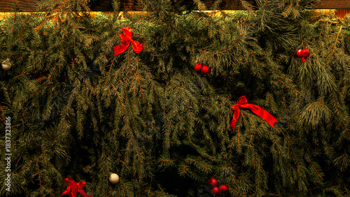 Lush evergreen branches adorned with red ribbons and berries create a warm, festive scene perfect for Christmas, family celebrations, and seasonal decor in marketing and media.