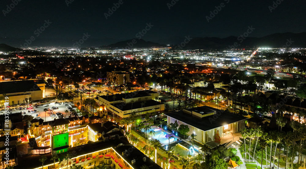 Fototapeta premium The Night Lights of Downtown Riverside, California from a UAV Drone Aerial view with the horizon in the background during the Christmas Holiday Season.